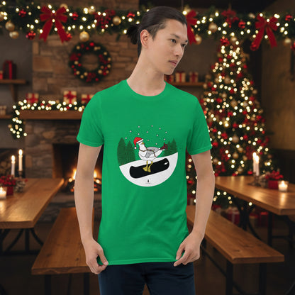 Man wearing an Irish green 100% cotton snowboarding seagull Christmas t-shirt, in a rustic cafe filled with red, green and gold Christmas decorations