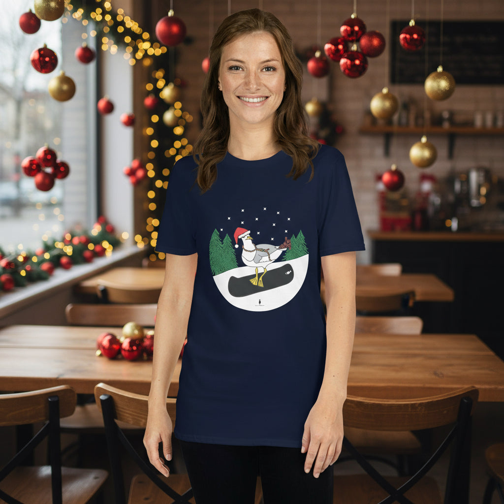 Woman wearing a navy blue 100% cotton snowboarding seagull Christmas t-shirt, in a rustic cafe filled with red, green and gold Christmas decorations